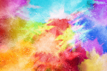 Freeze motion of colorful color powder exploding on white background.  Paint Holi.