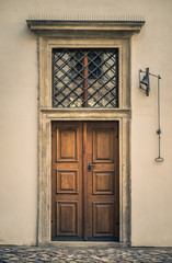 Fototapeta na wymiar Historic european wooden door with bell ringer