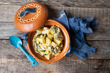 Mexican poblano rajas with potatoes and sour cream in clay cazuela