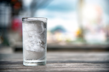 A glass of water placed on a wooden table