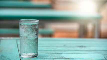 A glass of water placed on a wooden table