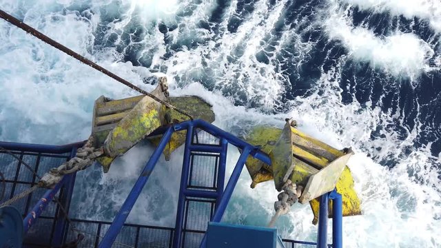 The anchor of tender assisted drilling oil rig (Barge Oil Rig) stored at the cow catcher during the rig move with wave hitting the anchor.