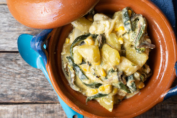 Mexican poblano rajas with potatoes and sour cream in clay cazuela
