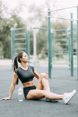  Meditation and rest sitting on the street. Beautiful athletic girl on the Playground.