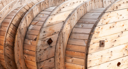 large wooden cable drums in bright sunshine