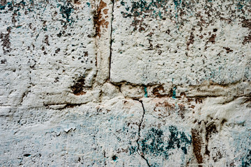 Texture of a brick wall with cracks and scratches which can be used as a background