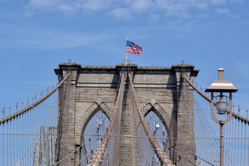 Fototapeta premium American flag on Brooklin Bridge, New York, USA