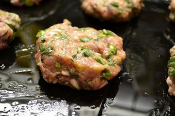 Raw cutlets on a baking sheet (semi-finished)