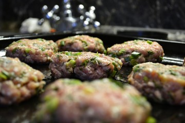 Raw cutlets on a baking sheet (semi-finished)