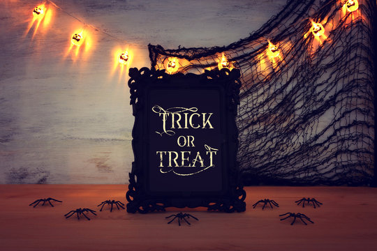 holidays image of Halloween. photo frame with text over wooden table