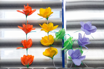 artificial paper flower on windowsill