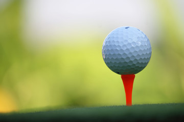 Golf ball on tee in the evening golf course with sunshine in thailand