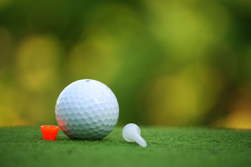 Golf ball on tee in the evening golf course with sunshine in thailand