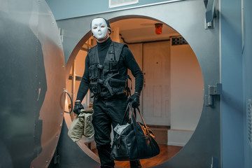 Bank robbery, robber in black uniform and mask