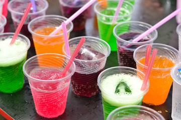 Colorful soft drink in plastic cup