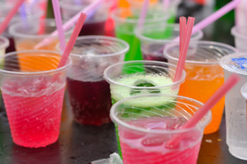 Colorful soft drink in plastic cup