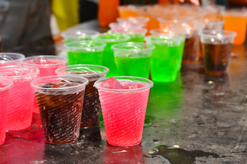 Colorful soft drink in plastic cup