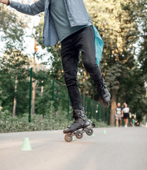 Roller skating, male teenager rolling on one leg