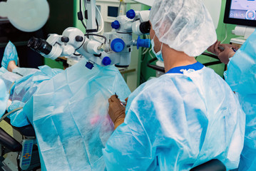 Doctors perform eye lens replacement operation with modern equipment