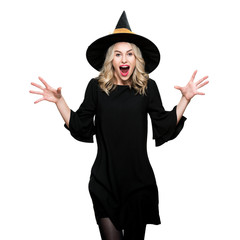 Attractive young woman dressed in witch halloween costume isolated over white background. Sensual...