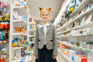 Little school girl in stationery store