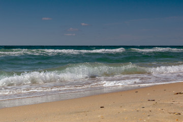 Fototapeta na wymiar sea wave running on the sandy shore
