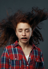 Strong wind blowing on woman's face, funny emotion