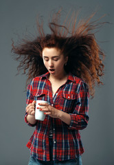 Strong wind blowing on woman's hair, funny grimace
