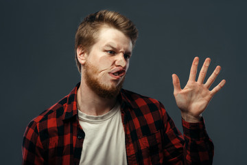 Man's crazy face crushed on transparent glass