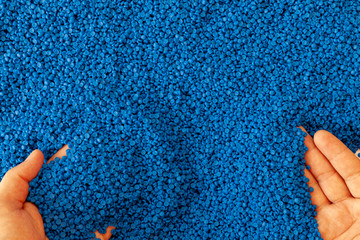 Close-up of plastic polymer granules. hand hold Polymer pellets. polymer plastic. compound polymer. - obrazy, fototapety, plakaty