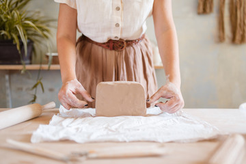 Female potter prepares a foarm, pottery workshop