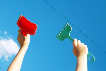  children's toys for sand in the hands. sky. background. shovel. rake