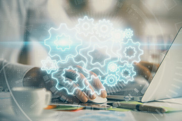 Obraz premium Multi exposure of businessman working on laptop on background. International business hologram in front. Concept of success.