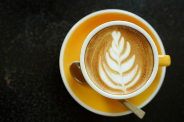 Coffee Latte leaf pattern face on black table