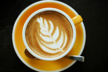 Coffee Latte leaf pattern face on black table