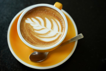 Coffee Latte leaf pattern face on black table