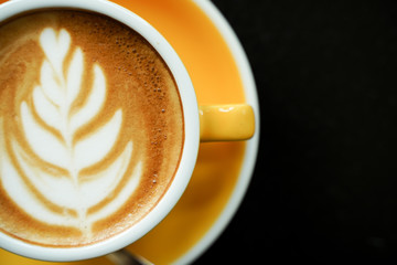 Coffee Latte leaf pattern face on black table