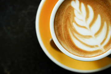 Coffee Latte leaf pattern face on black table