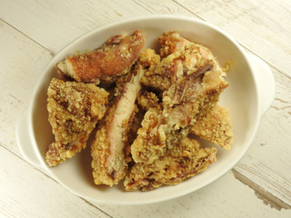 Top view of a plate of fried chicken cutlet (also call fried chicken chop) on wooden background. Taiwan night market food. Fried chicken cutlets is Taiwanese specialty. With copy space.