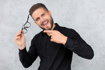 Attractive man dressed casual, wearing glasses - studio shot, copy space