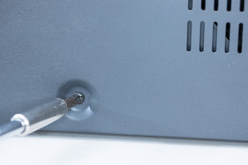 Close up of Phillips screw and hex head screwdriver