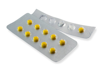 Yellow pills in the panel on a white background,with clipping path