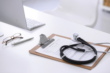 Stethoscope, prescription medical form lying on a table with pc computer. Medicine or pharmacy concept. Medical tools at doctor working table