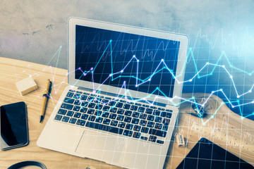 Multi exposure of chart and financial info and work space with computer background. Concept of...