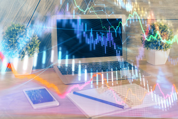Financial graph colorful drawing and table with computer on background. Double exposure. Concept of international markets.