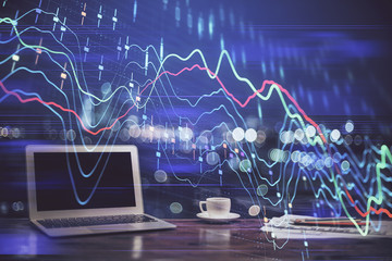 Stock market chart hologram drawn on personal computer background. Double exposure. Concept of investment.