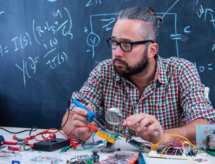 Tech postgraduate student working on electronic project