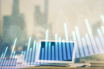 Forex Chart hologram on table with computer background. Multi exposure. Concept of financial markets.