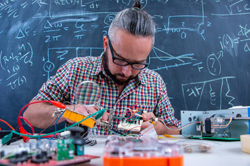 Tech postgraduate student working on electronic project