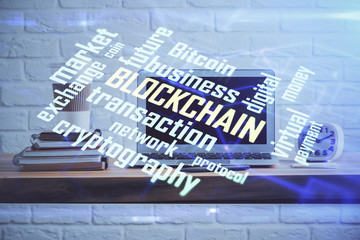 Multi exposure of blockchain theme hologram and table with computer background. Concept of bitcoin crypto currency.